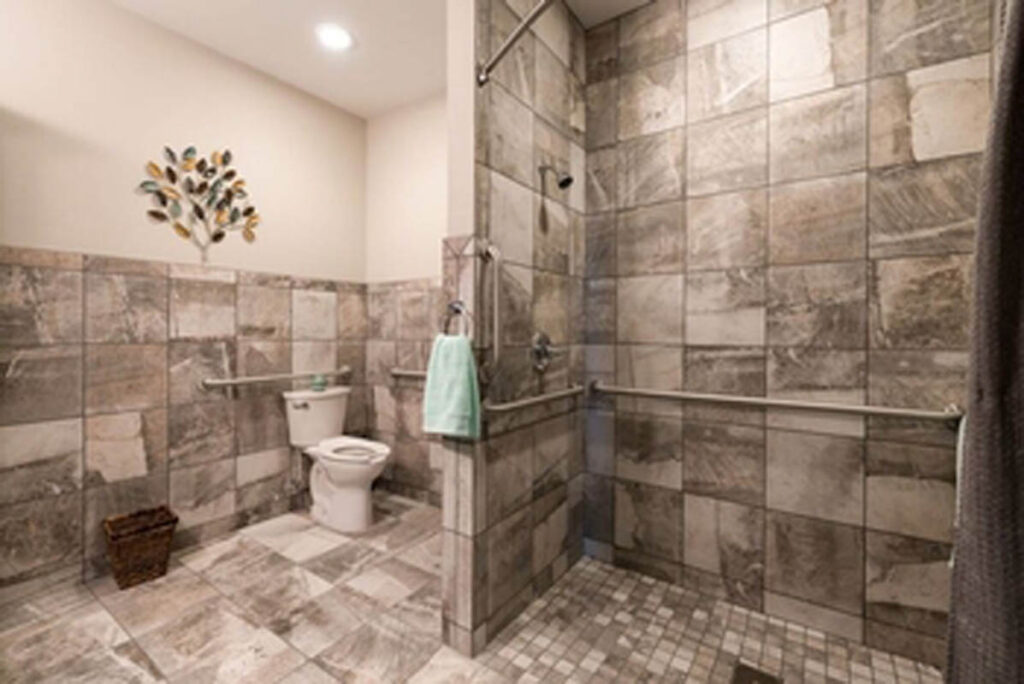 Accessible bathroom with tiled walls and grab bars