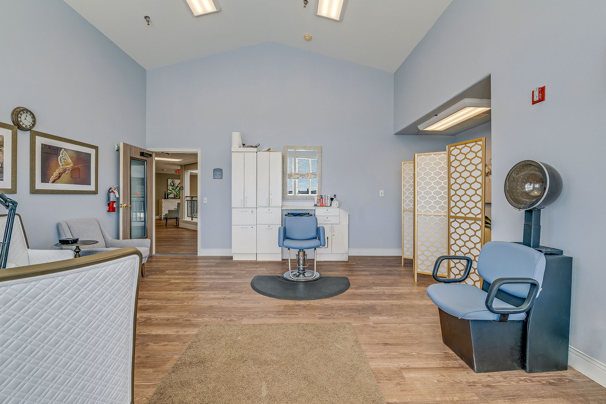 Interior view of a salon area with chairs and mirrors.