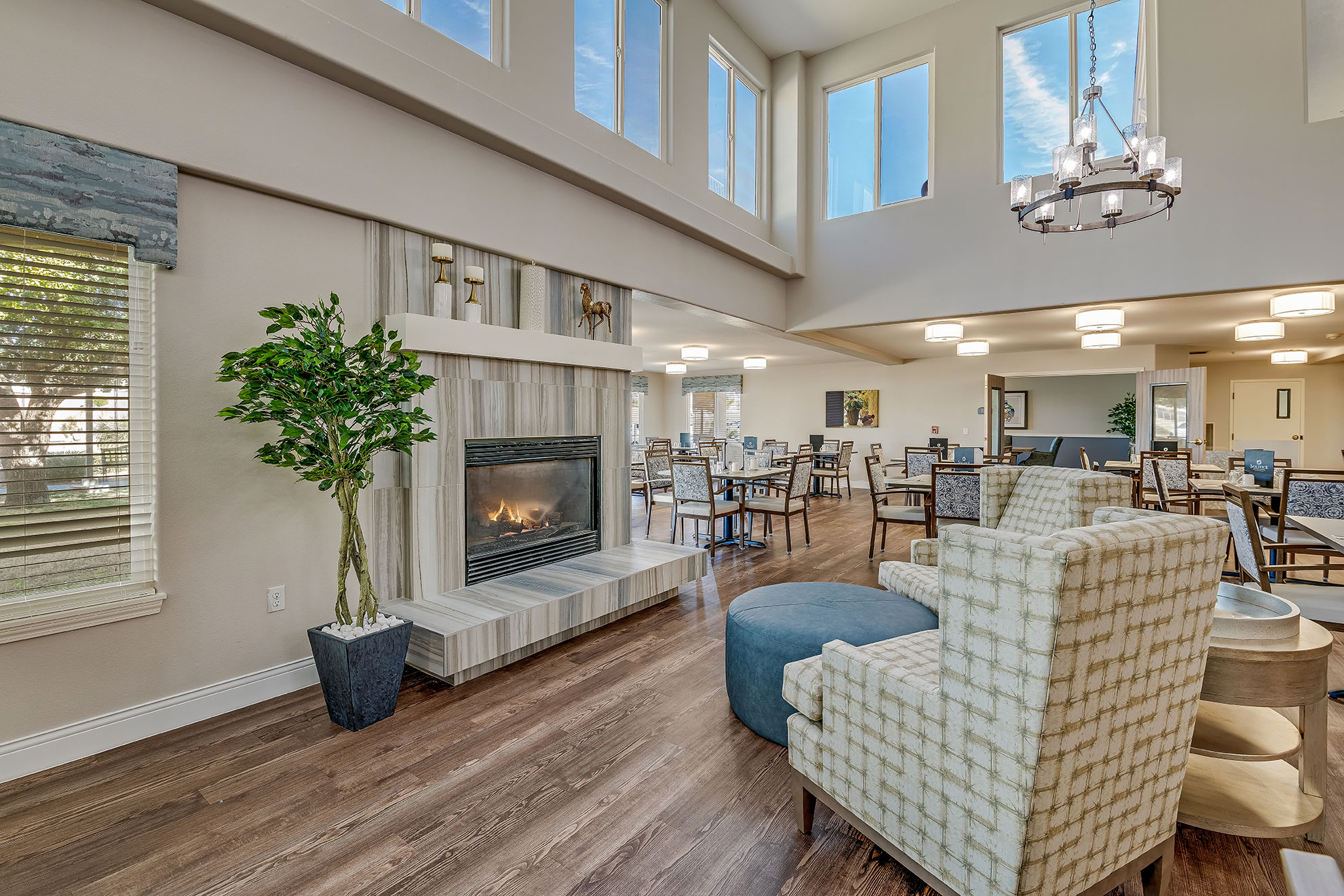 Common area with fireplace and seating in a senior living facility