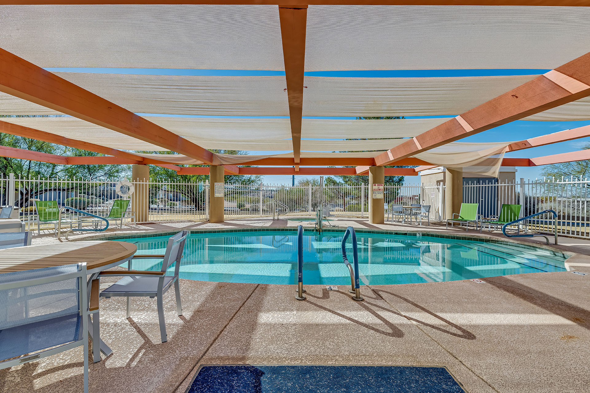 Outdoor pool area with shaded seating