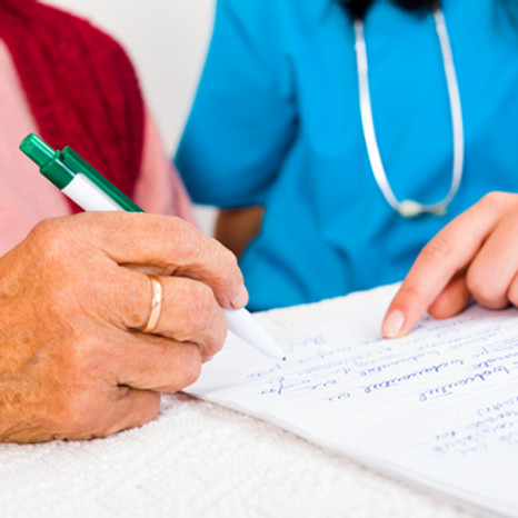 A caregiver assisting a senior with documents.