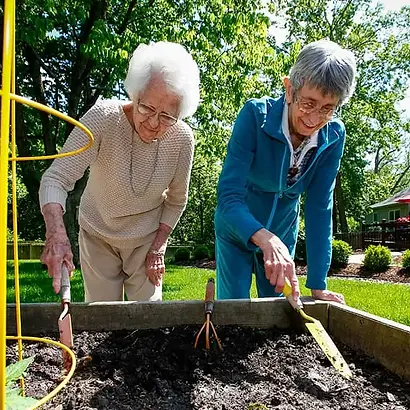 Two residents gardening outdoors together