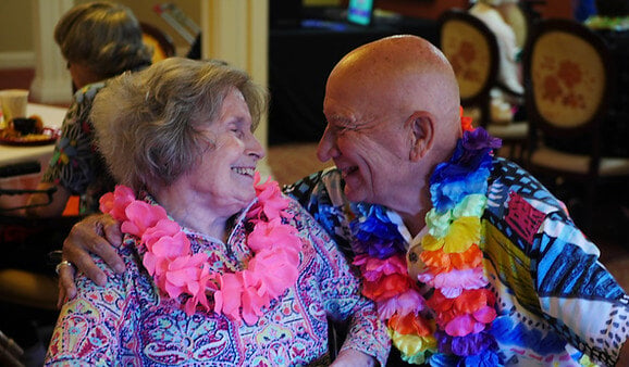 Two residents enjoying a joyful moment together indoors.