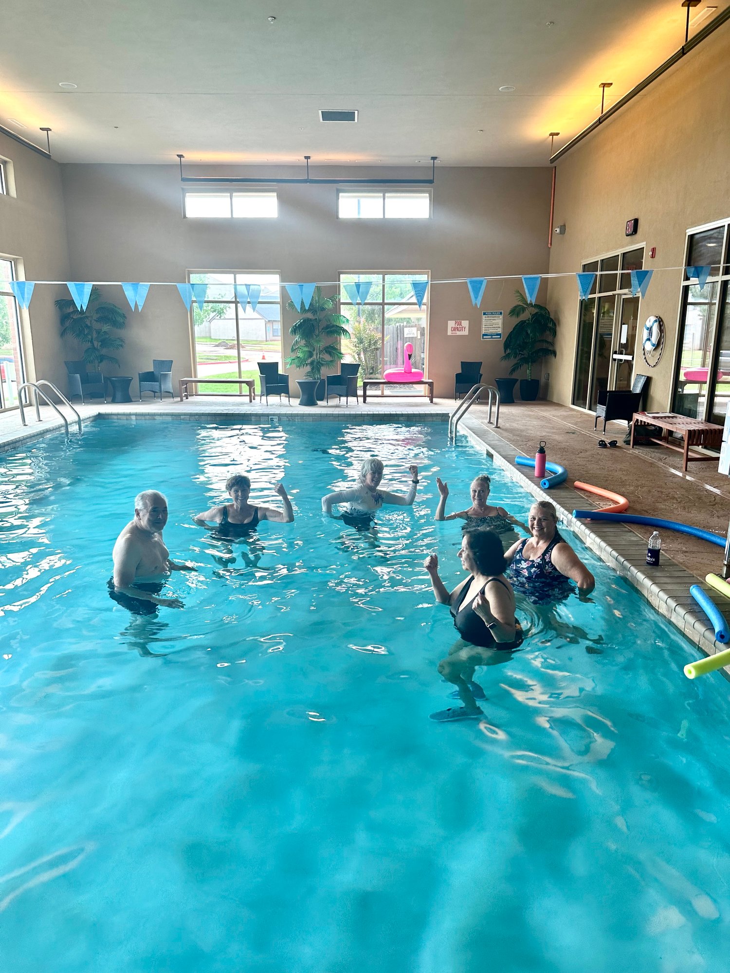 Residents enjoying a water exercise class in the pool