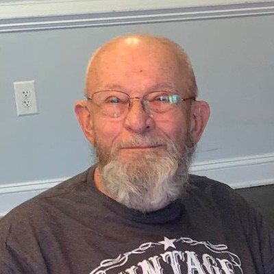 Elderly man smiling in a casual setting