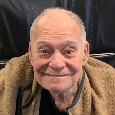 Smiling elderly man in a cozy setting.