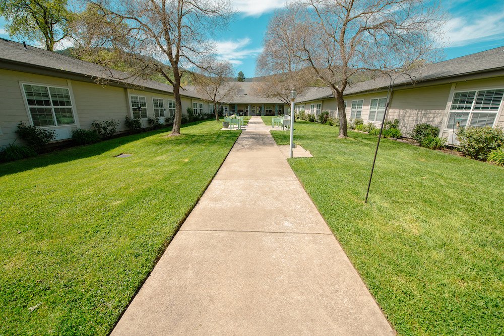 Pathway leading to residential facility with outdoor space.