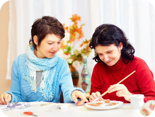 Two women engaged in a crafting activity.