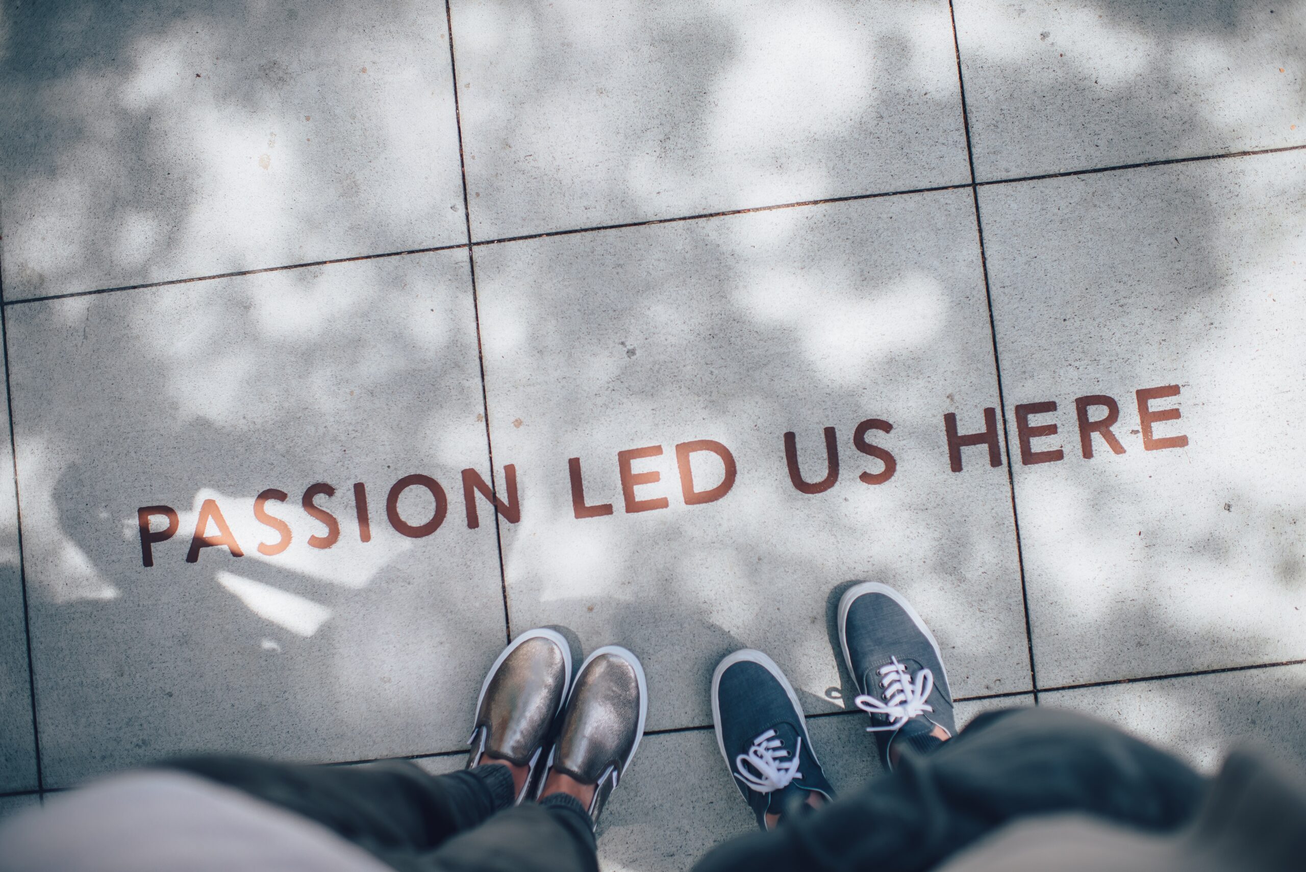 Feet standing on a pathway with motivational text