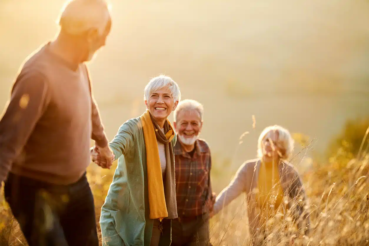 Seniors enjoying a walk in a grassy field
