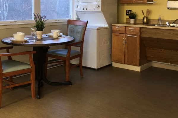Cozy dining area with kitchen appliances.