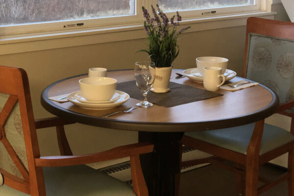 Dining table set for a meal in a common area