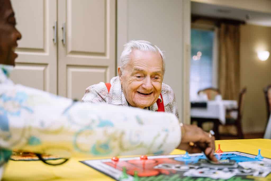 Residents enjoying a game together in the activity room.