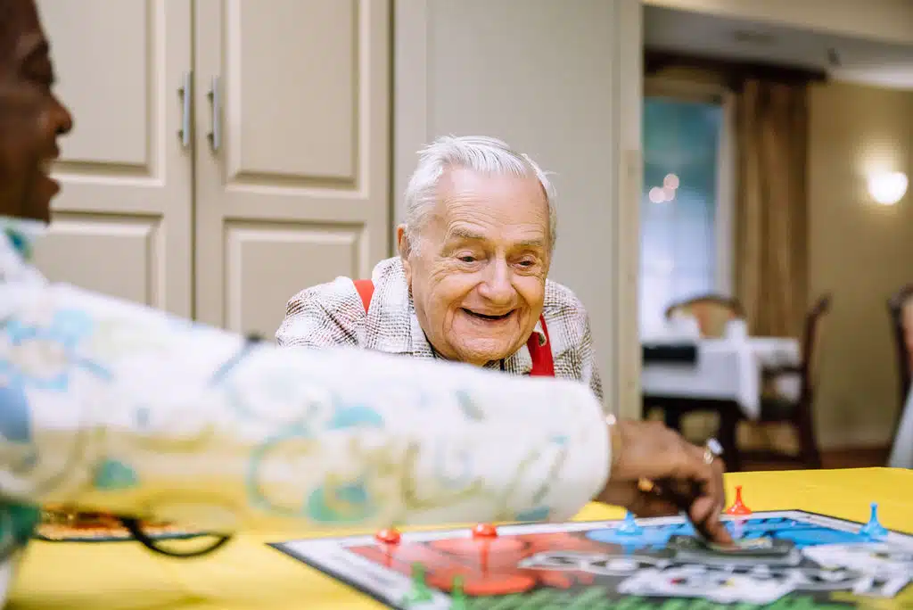 Seniors playing a board game together.