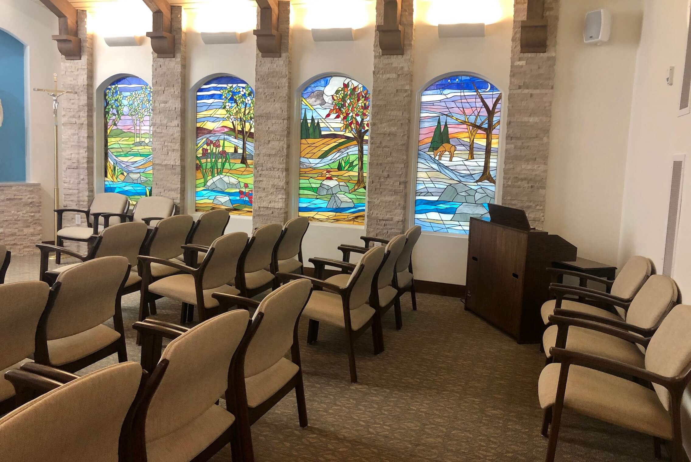 Interior chapel with stained glass windows and seating