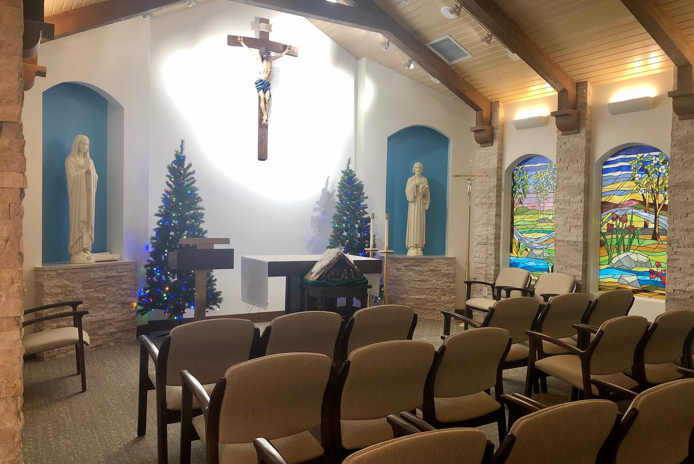 Interior view of a chapel with Christmas decor.