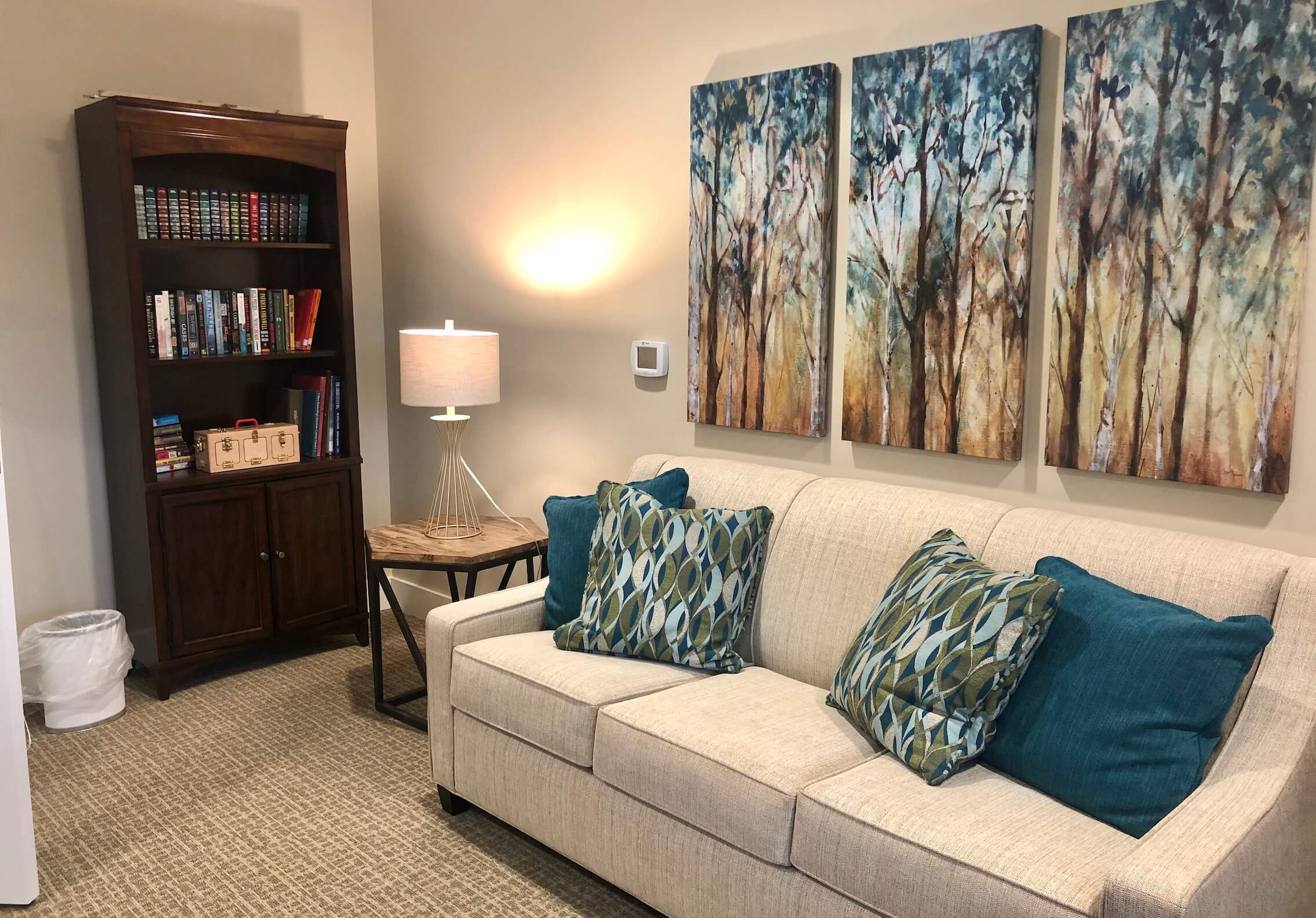 Cozy interior space with furniture and artwork.