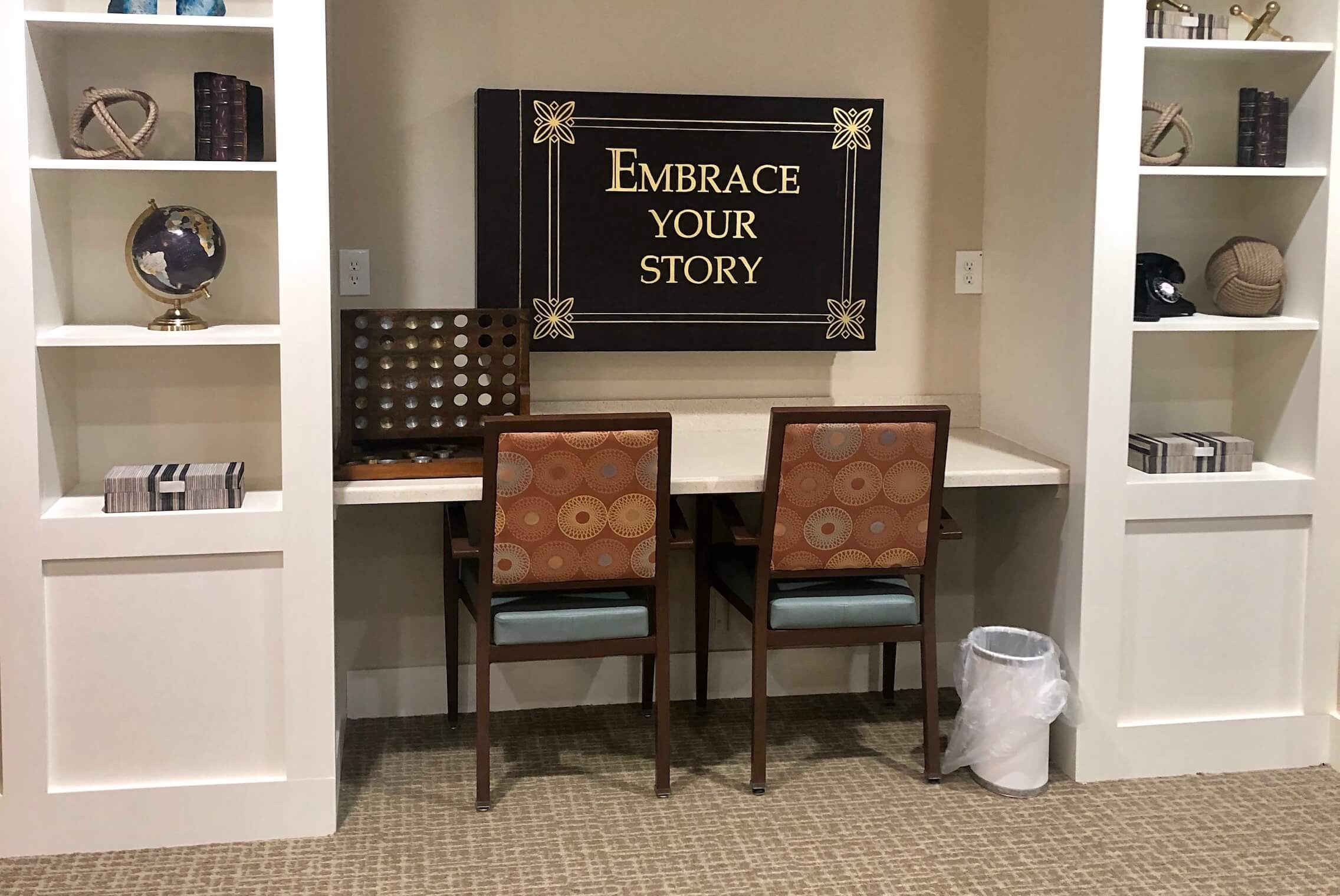 Interior corner with two chairs and a decorative sign