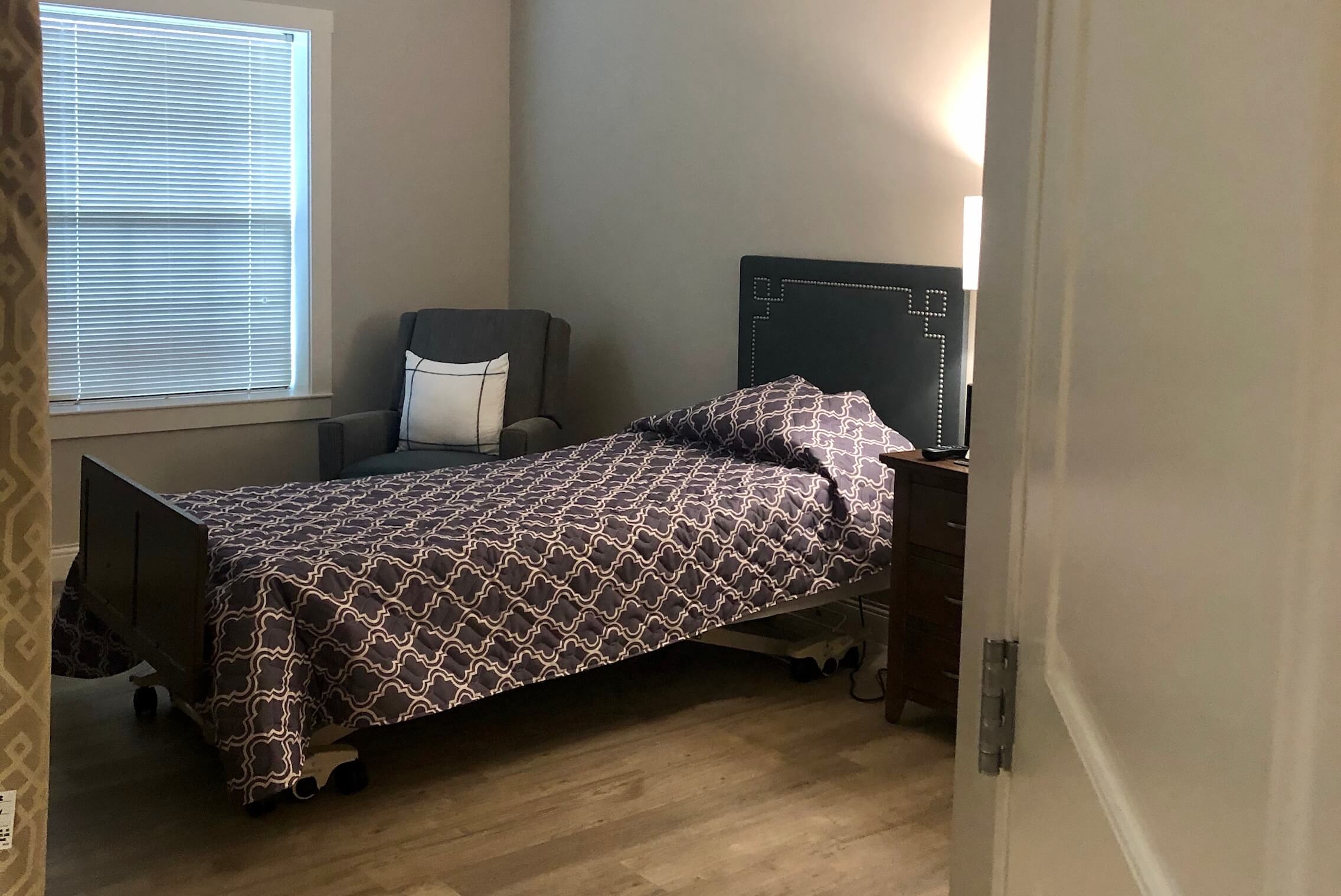 Cozy resident bedroom with a bed and chair.