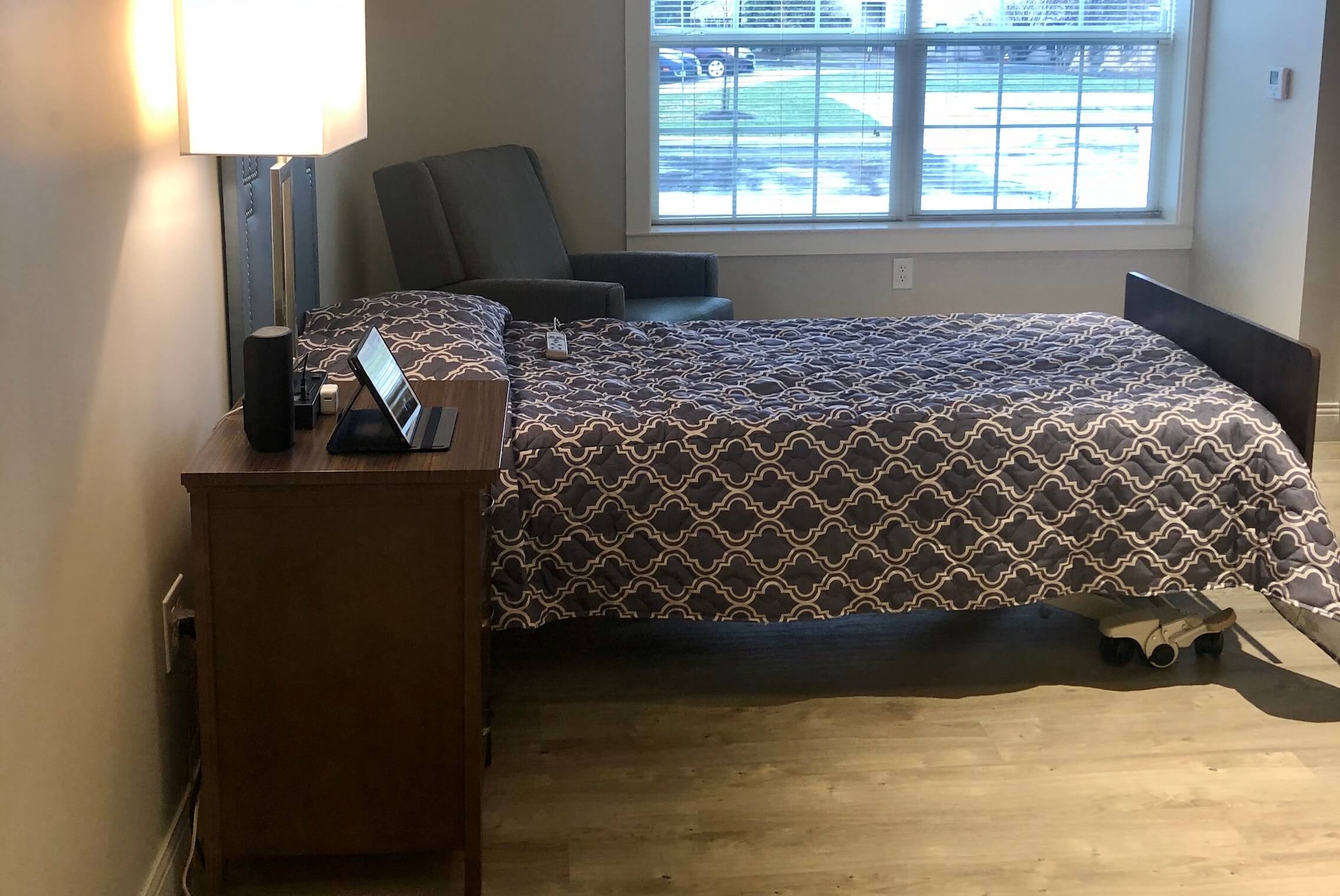 Styled resident room with bed and seating