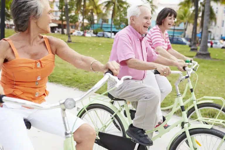 Seniors riding bicycles in a park
