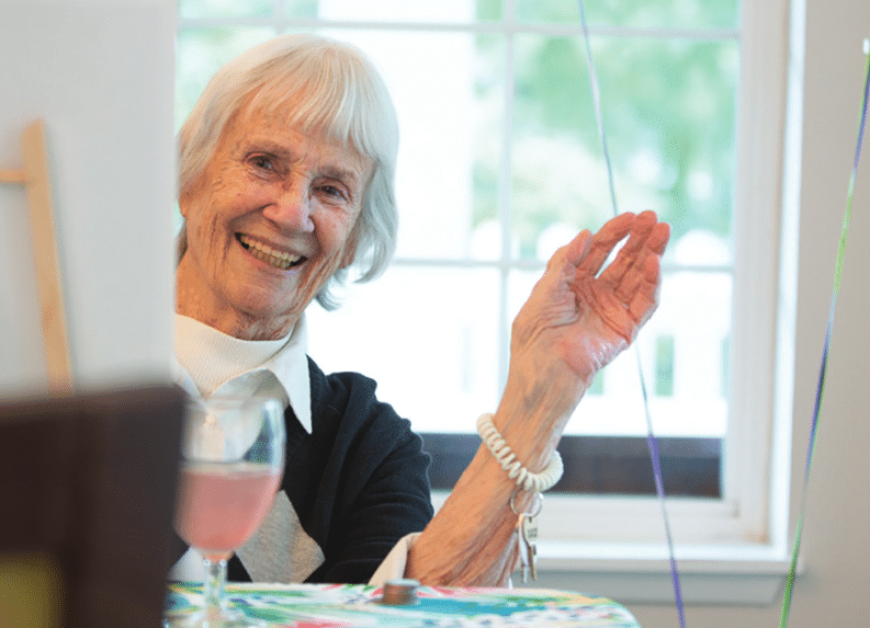 Resident happily waving in a common area