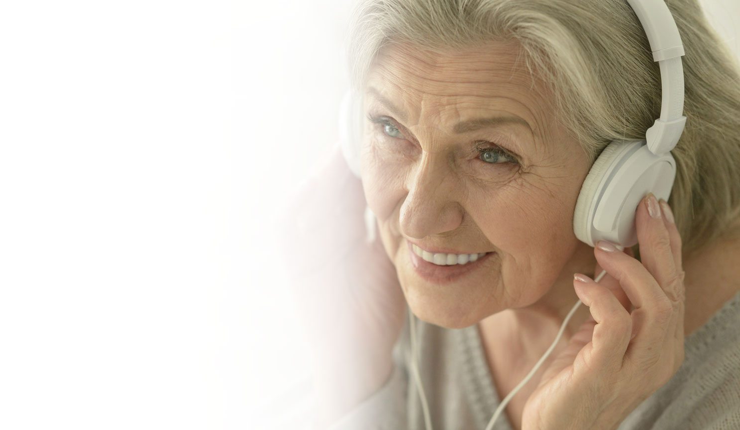 Elderly woman listening to music with headphones