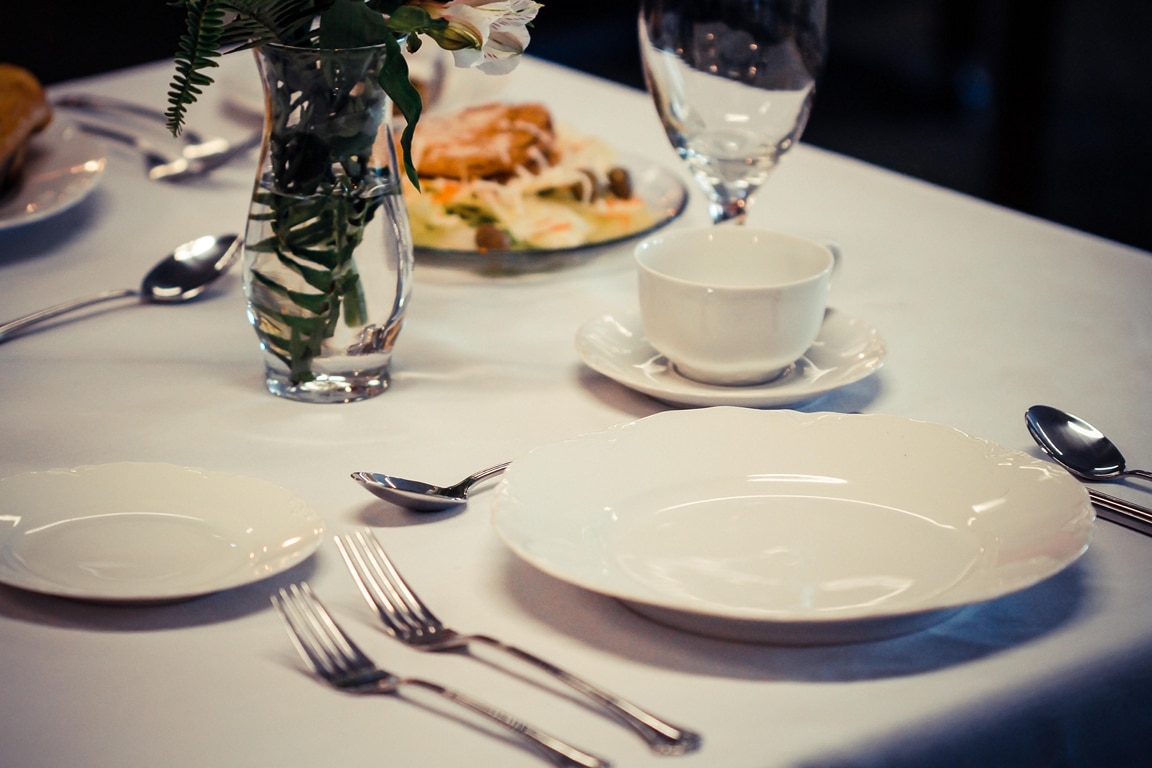 Elegant dining setup with plates and silverware.