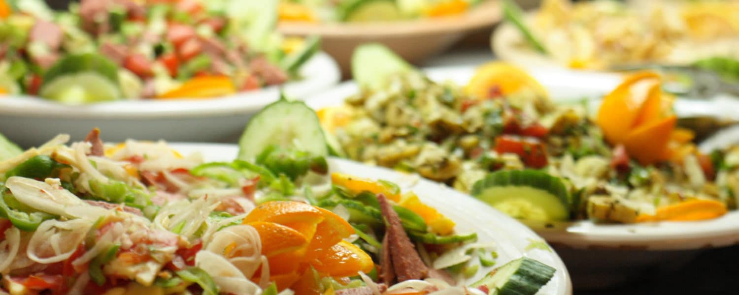 Close-up of a variety of salads and food platters.