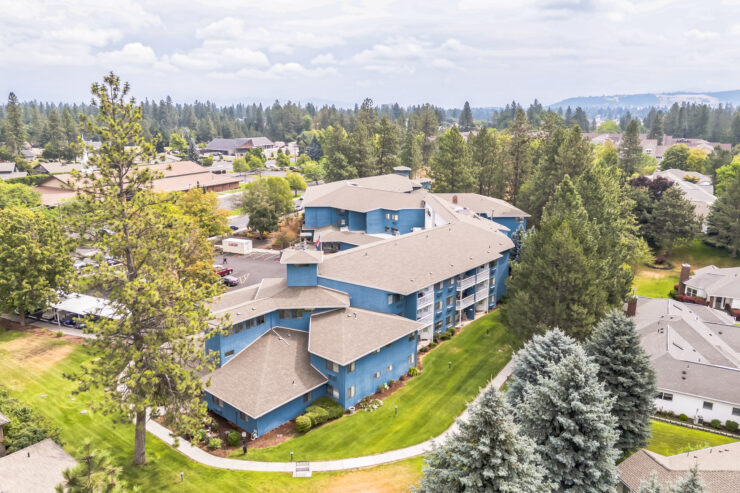 Aerial view of the assisted living facility surrounded by greenery.