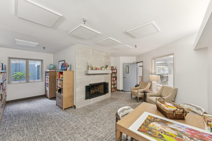 Cozy common area with bookshelves and seating.