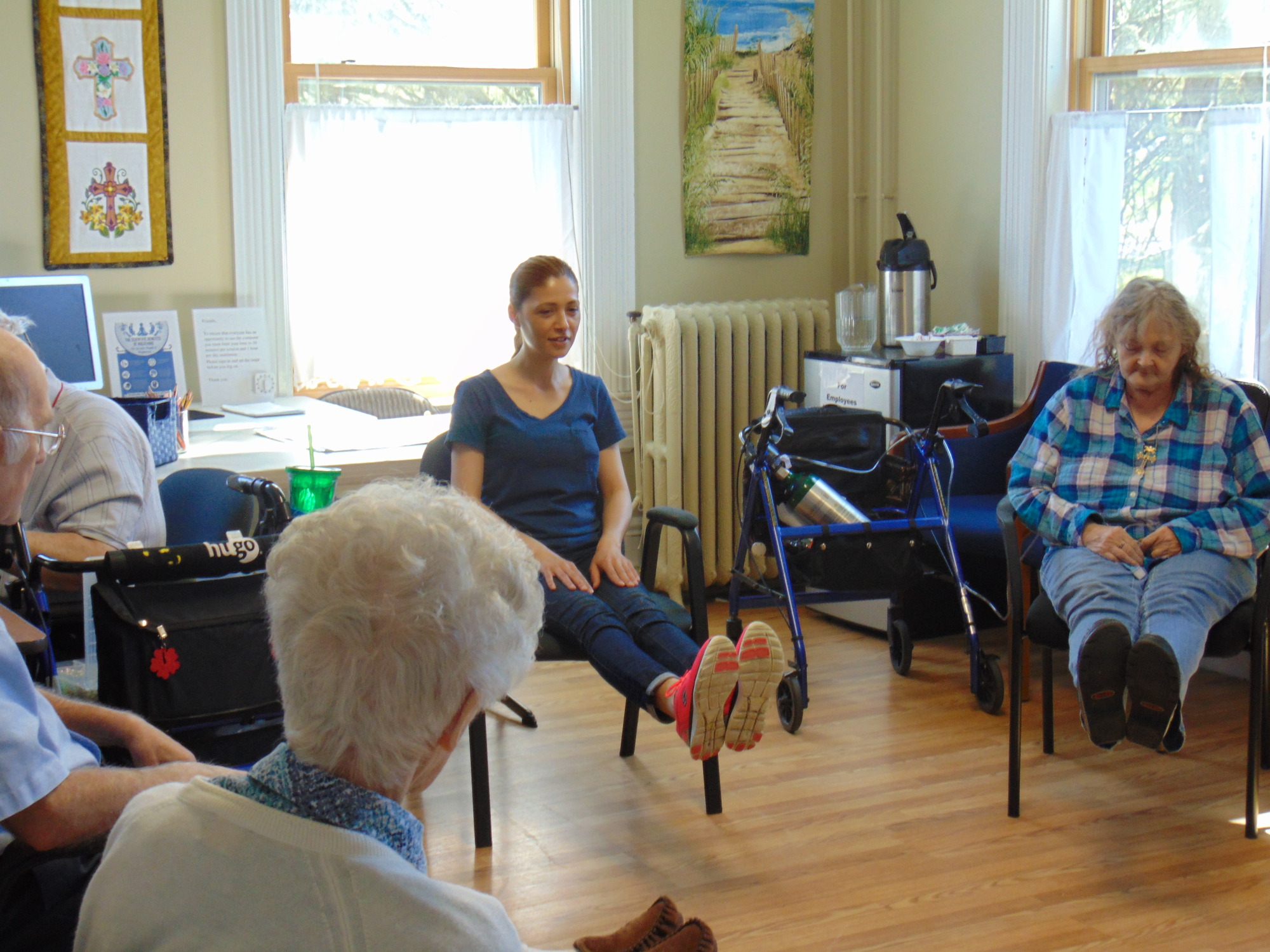 Residents participating in a seated exercise class.