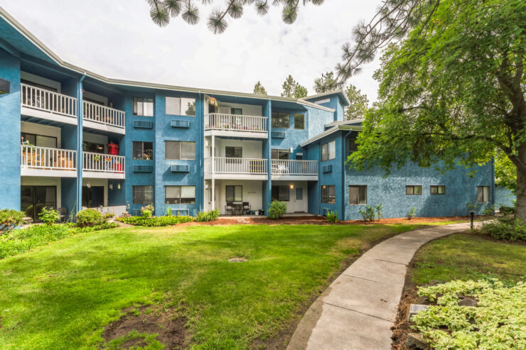 Exterior view of the assisted living facility surrounded by green spaces.