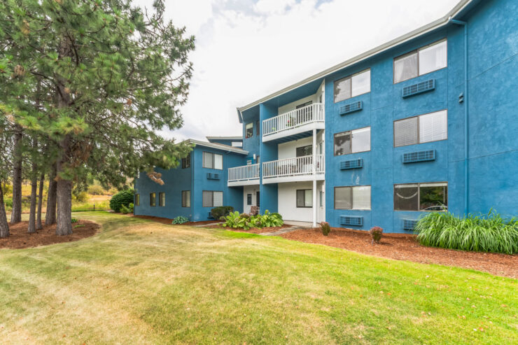 Exterior view of a blue assisted living building.