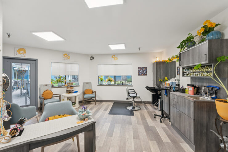 Brightly lit salon area with seating and decor.