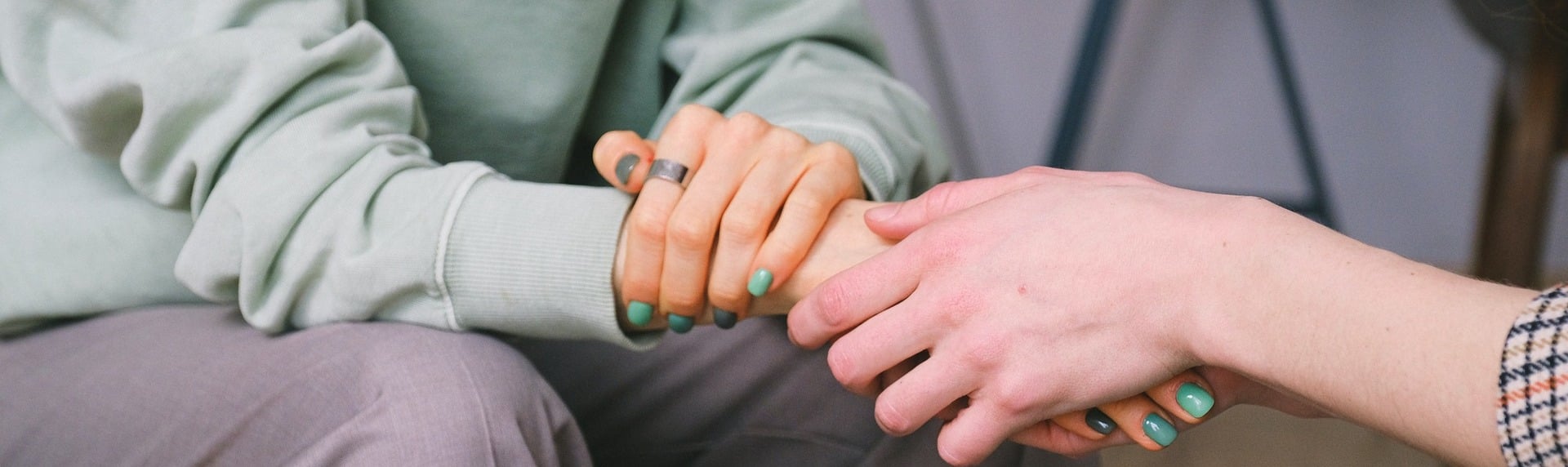 Two hands holding in a supportive gesture