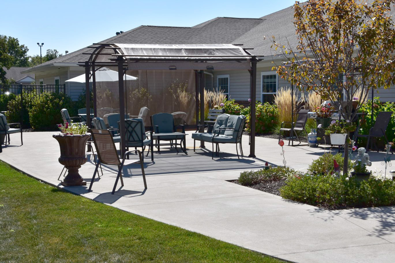 Outdoor seating area with shaded pergola and garden