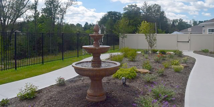 Outdoor garden with a fountain and landscaping.
