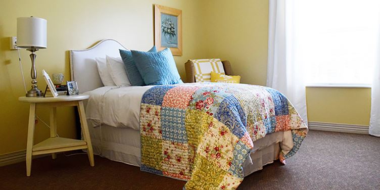 Cozy resident room with a colorful quilt and decor