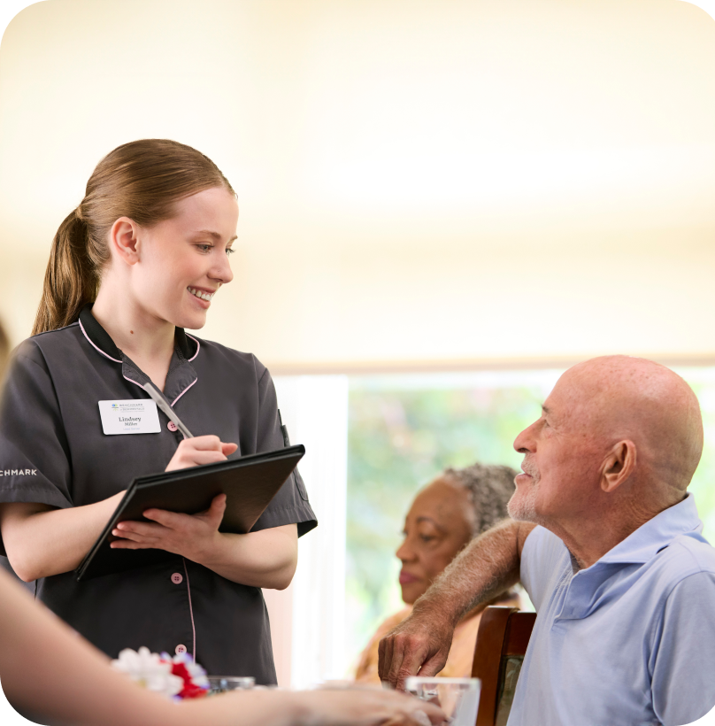 Staff interacting with a resident in a shared space.