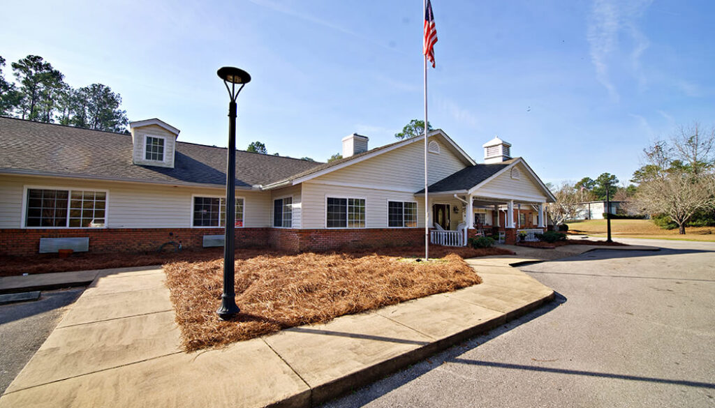 Exterior view of Magnolia Place with American flag