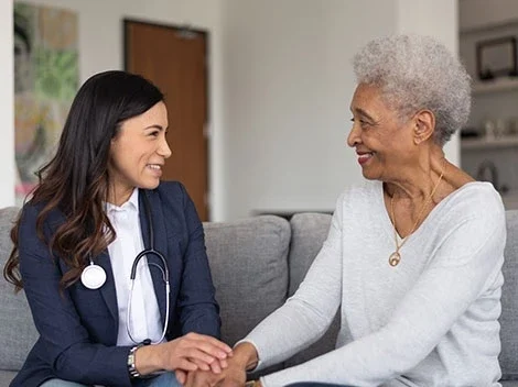 A caregiver and a resident sharing a moment.