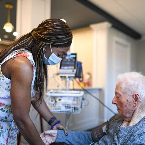 Caregiver assisting an elderly resident in a facility