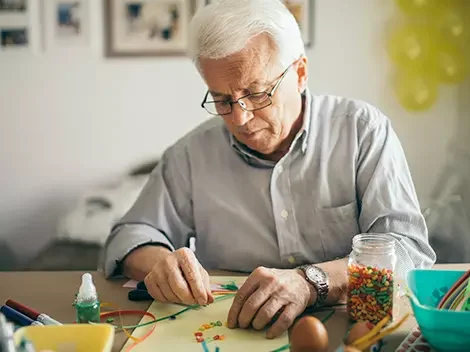 Elderly man engaged in a craft activity.