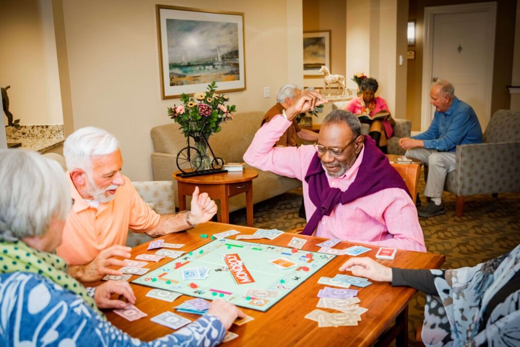 Residents enjoying a game in a common area.