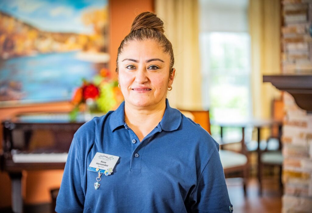 Staff member smiling in common area.