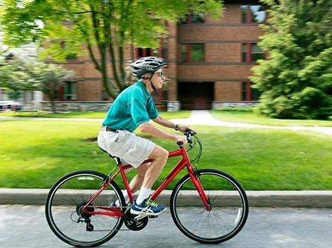 Senior man cycling near the facility