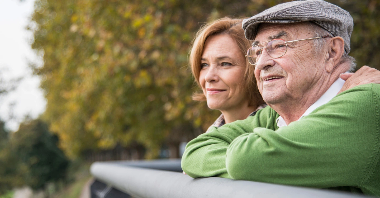 Elderly man and woman enjoying outdoors together.