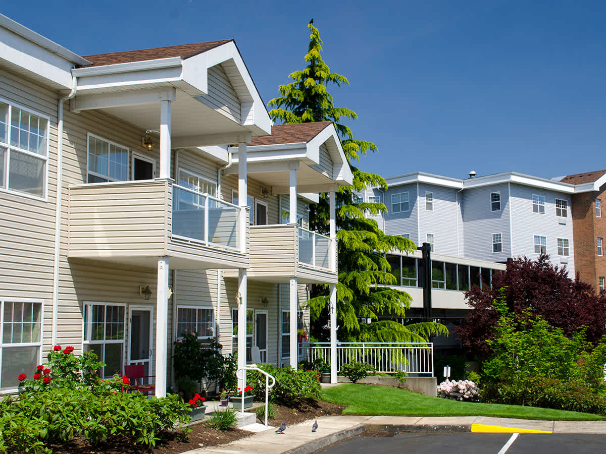 Exterior view of the facility with gardens and balconies.