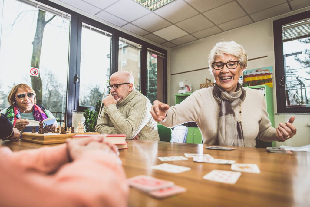 Seniors enjoying a card game together indoors.